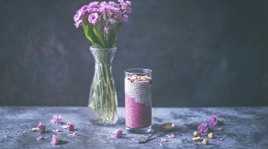 Glass of vibrant red beetroot powder drink with chia seeds and lemon slice for weight loss