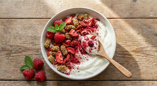 A bowl of oatmeal topped with Naturya Gut Feel Flaxseed Blend and fresh fruit, beside a packet of Naturya organic superfoods on a wooden table.